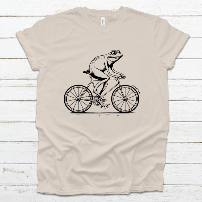 Loveland Frogman on Bike T-Shirt on Oatmeal--Lemons and Limes Boutique