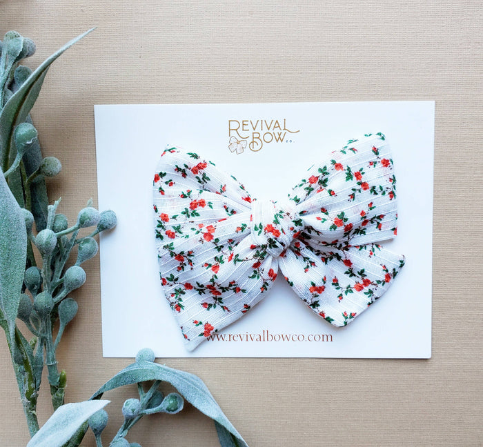 Christmas Bow on Clip in Festive Floral--Lemons and Limes Boutique